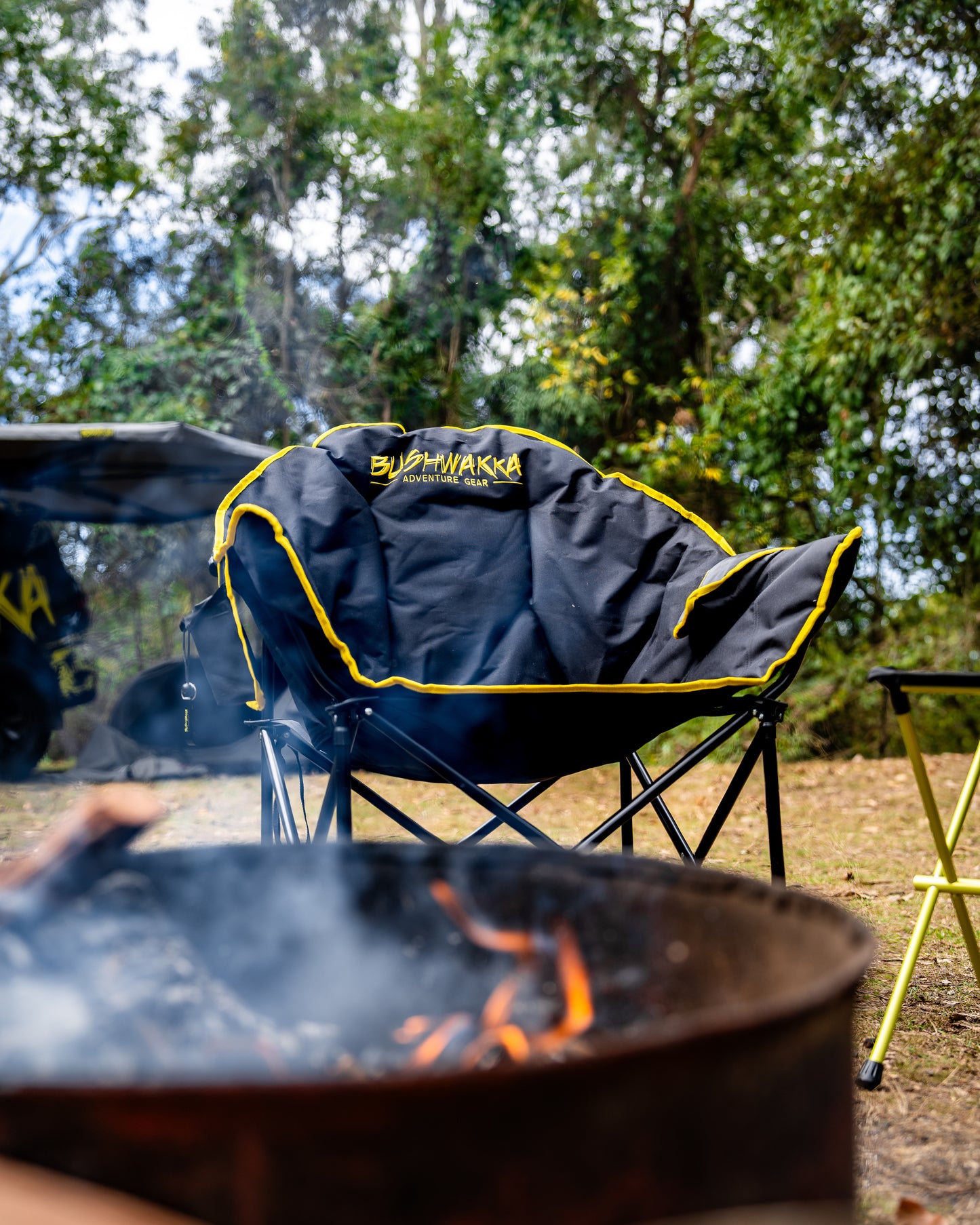 burning campfire in front of folding chair