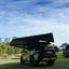 rooftop tent on a black car with bushwakka branding